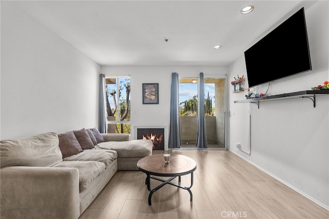 19350 Sherman Way Unit 204, Reseda, CA 91335 - living room with light wood-type flooring, recessed lighting, and a lit fireplace
