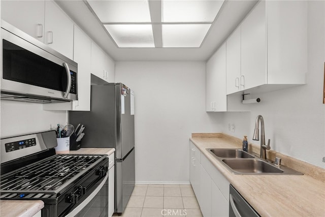 19350 Sherman Way Unit 204, Reseda, CA 91335 - kitchen with stainless steel appliances, white cabinetry, light countertops, and light tile patterned flooring