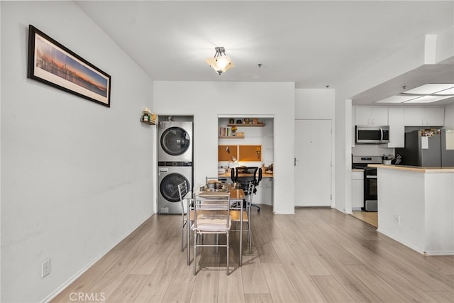19350 Sherman Way Unit 204, Reseda, CA 91335 - dining area featuring stacked washer / drying machine and light wood-type flooring