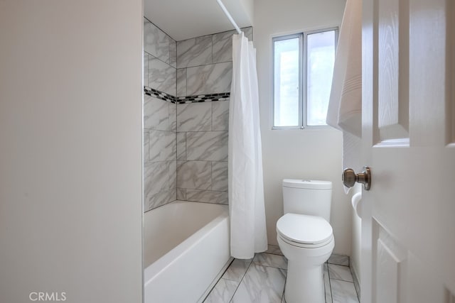 bathroom featuring shower / bath combo with shower curtain, marble finish floor, and toilet