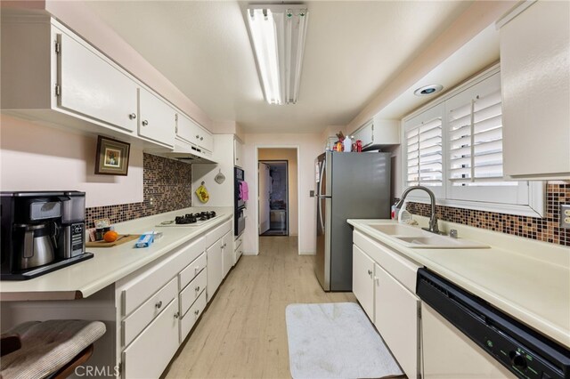 21322 Millpoint Ave, Carson, CA 90745 - kitchen featuring light countertops, a sink, light wood finished floors, white cabinetry, and white appliances