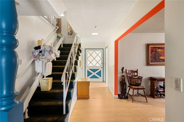 21322 Millpoint Ave, Carson, CA 90745 - stairway featuring a textured ceiling and wood finished floors