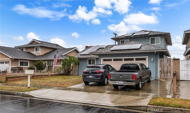 21322 Millpoint Ave, Carson, CA 90745 - view of front of home featuring driveway, a garage, roof mounted solar panels, and fence