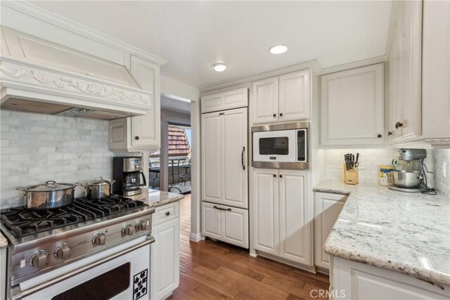 2545 Via Campesina Unit 303, Palos Verdes Estates, CA 90274 - kitchen with stainless steel appliances, premium range hood, decorative backsplash, white cabinetry, and recessed lighting