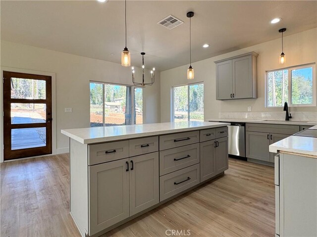 6296 Chatham Ct, Magalia, CA 95954 - kitchen featuring visible vents, plenty of natural light, light countertops, gray cabinets, and light wood-style flooring