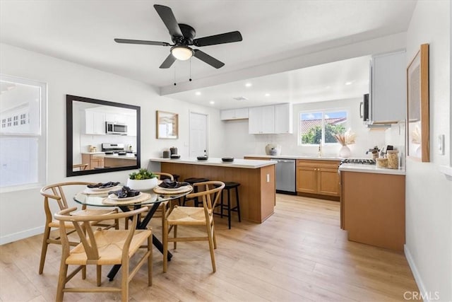 dining space with light wood-style flooring, baseboards, ceiling fan, and recessed lighting