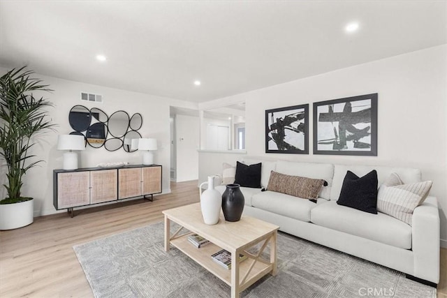 living room featuring visible vents, recessed lighting, and wood finished floors