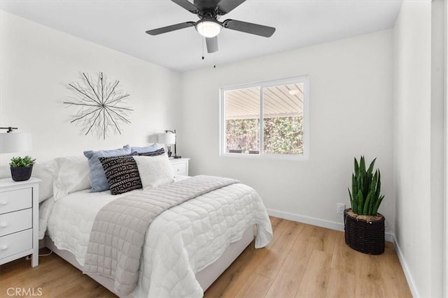 bedroom with baseboards, light wood-style flooring, and a ceiling fan