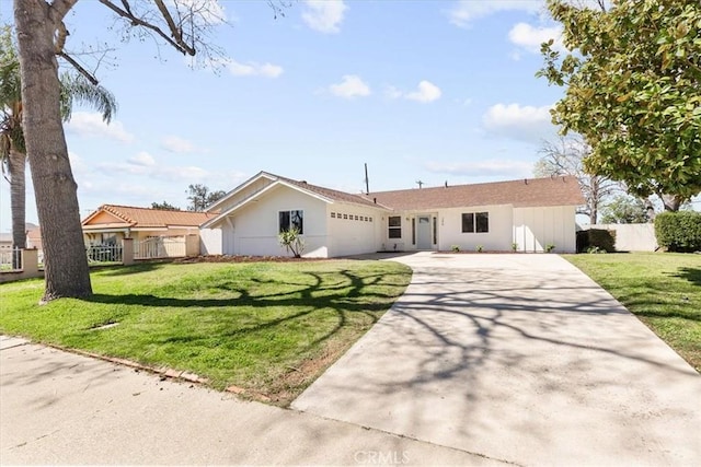 single story home featuring a front lawn, driveway, an attached garage, and fence