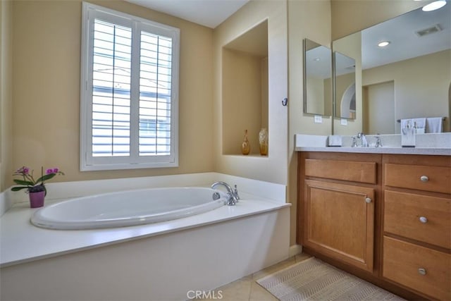 full bathroom with vanity, visible vents, tile patterned flooring, and a bath