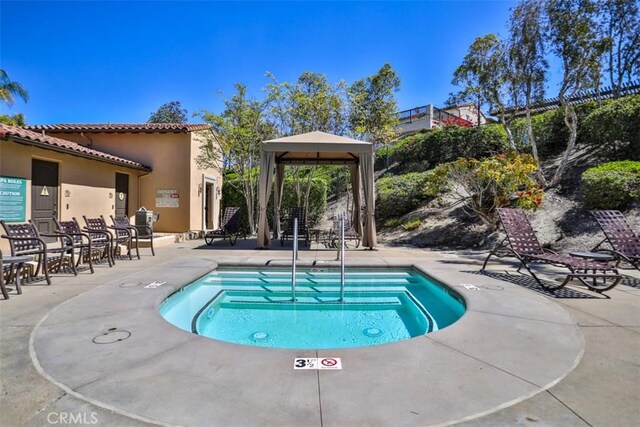 view of pool with a gazebo, a pool, and a patio area