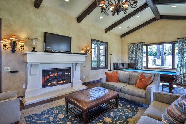 living room with a notable chandelier, high vaulted ceiling, a glass covered fireplace, billiards, and beamed ceiling