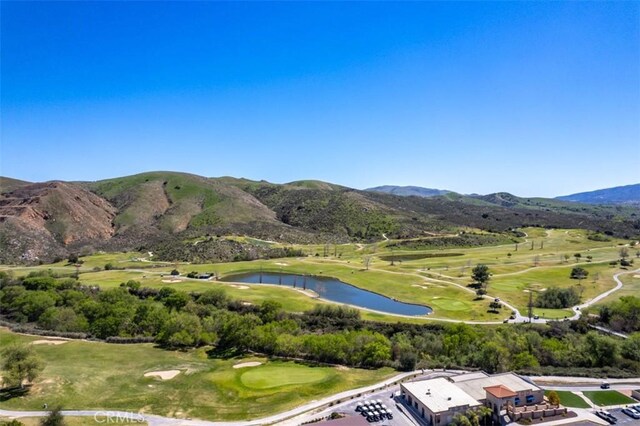 mountain view featuring view of golf course and a water view