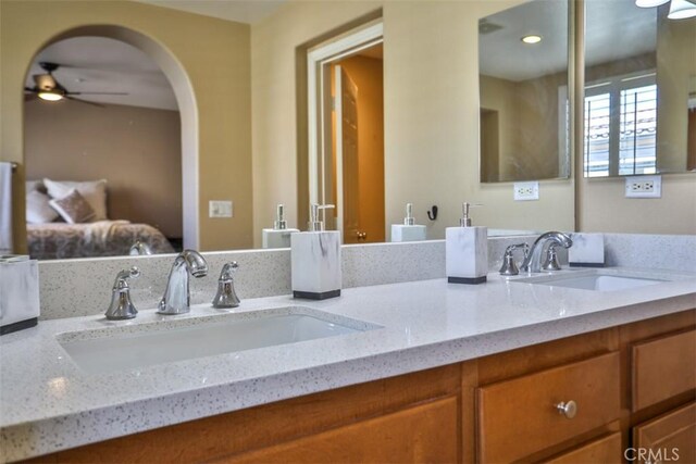 bathroom featuring double vanity, a sink, and a ceiling fan