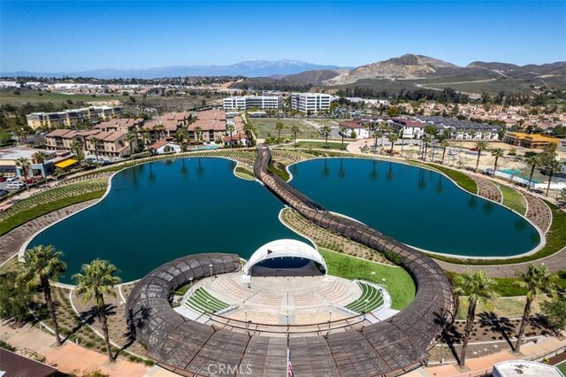 birds eye view of property featuring a water and mountain view