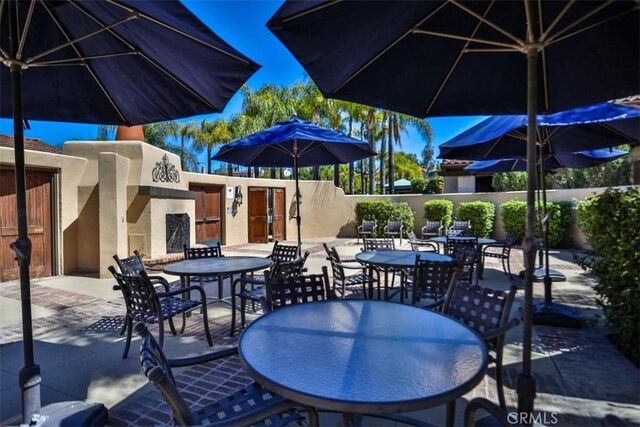view of patio with outdoor dining area and fence