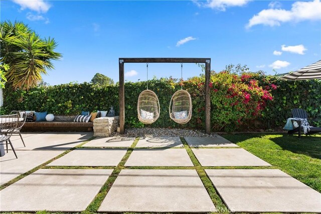 view of patio / terrace featuring fence