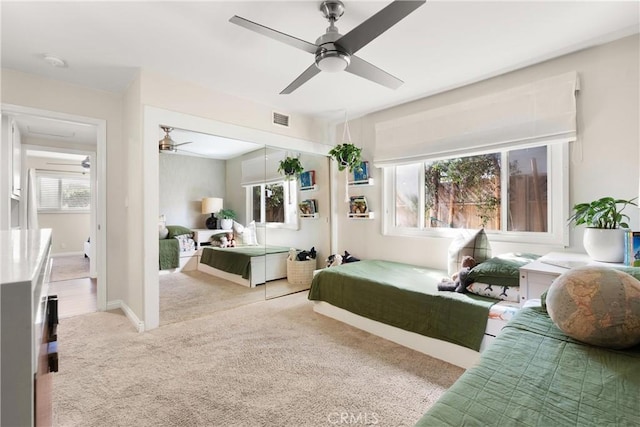 carpeted bedroom featuring visible vents and ceiling fan