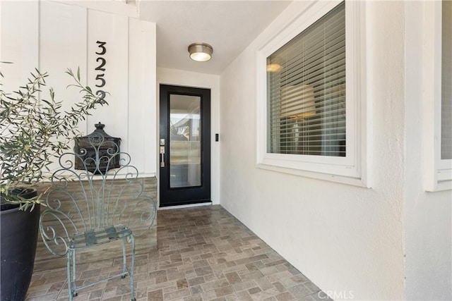 view of exterior entry with stucco siding