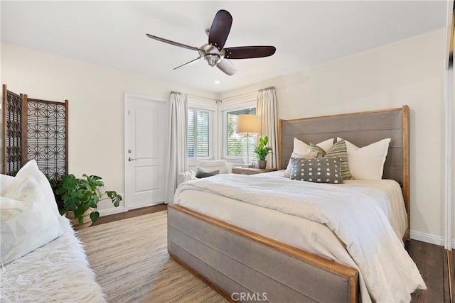bedroom featuring baseboards, a ceiling fan, and wood finished floors
