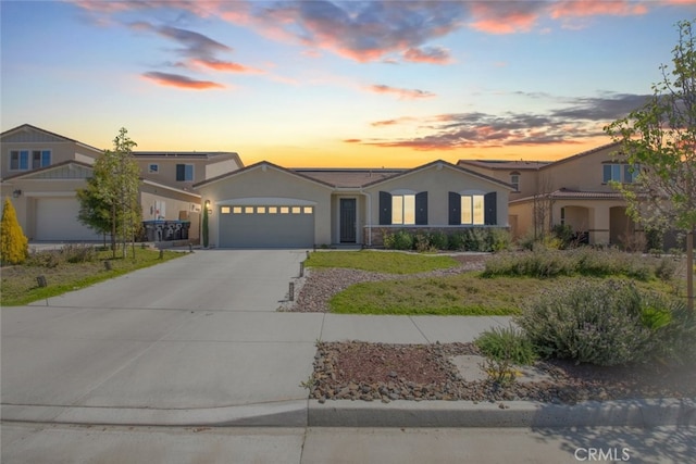 36082 Saint Claire Ct, Winchester, CA 92596 - view of front of home featuring driveway, an attached garage, and stucco siding