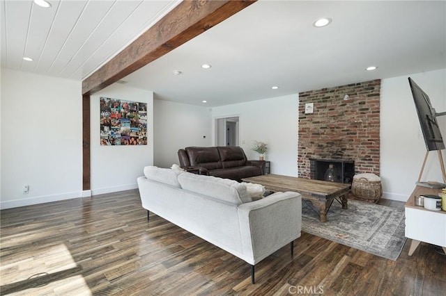 living area with baseboards, recessed lighting, beamed ceiling, wood finished floors, and a fireplace