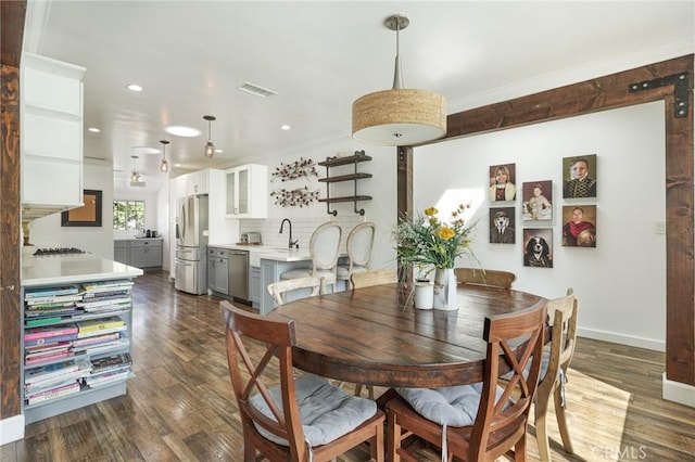 dining space with baseboards, ornamental molding, dark wood-type flooring, visible vents, and recessed lighting