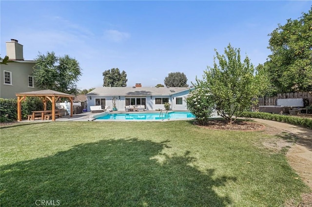 rear view of property with a gazebo, a lawn, a patio, and an outdoor pool