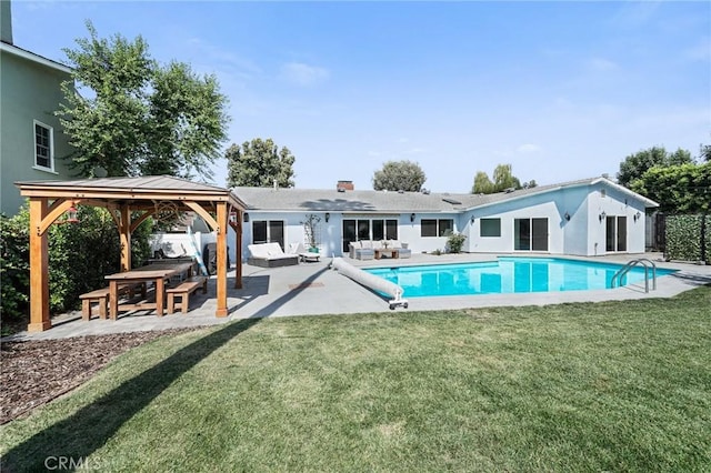 pool with outdoor lounge area, a yard, a patio, and a gazebo