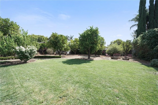 view of yard with an outdoor fire pit