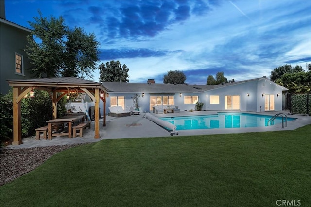 outdoor pool with an outdoor living space, a patio area, a lawn, and a gazebo