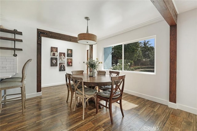dining room featuring ornamental molding, baseboards, and dark wood-style flooring