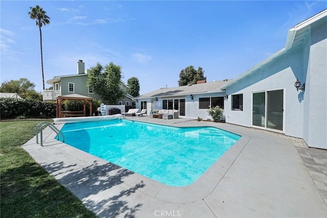 view of swimming pool with a gazebo, a fenced in pool, a patio area, and an outdoor living space