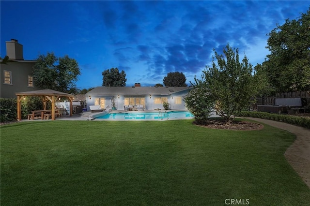 exterior space featuring a patio area, a lawn, a fenced in pool, and a gazebo