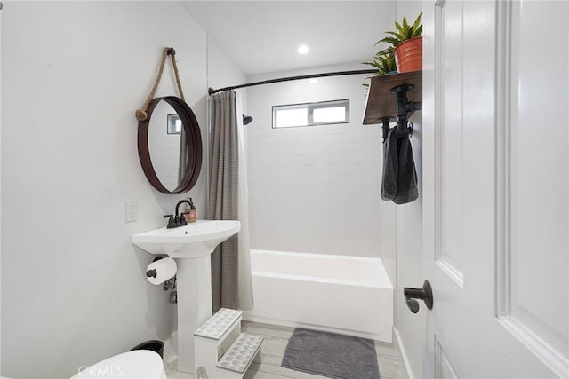 bathroom featuring shower / bath combo and toilet