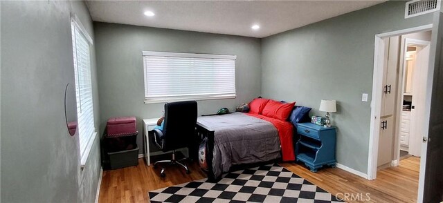 bedroom featuring light wood-style flooring, baseboards, and recessed lighting