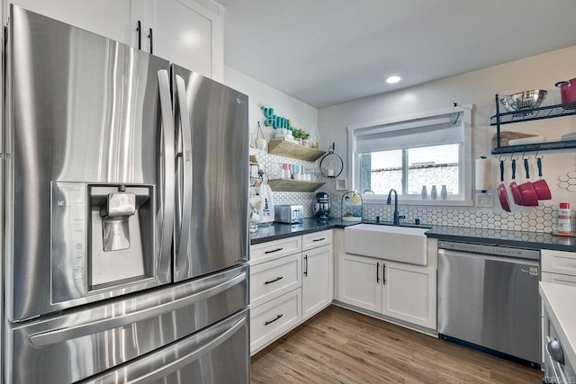 2760 Thunder Dr, Oceanside, CA 92056 - kitchen with appliances with stainless steel finishes, open shelves, tasteful backsplash, white cabinetry, and recessed lighting