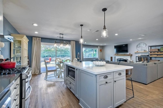 2760 Thunder Dr, Oceanside, CA 92056 - kitchen with appliances with stainless steel finishes, recessed lighting, a breakfast bar area, healthy amount of natural light, and a kitchen island