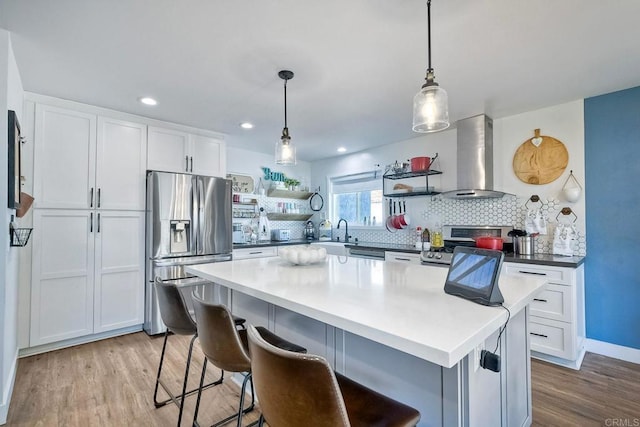 2760 Thunder Dr, Oceanside, CA 92056 - kitchen featuring appliances with stainless steel finishes, ventilation hood, open shelves, light wood finished floors, and tasteful backsplash