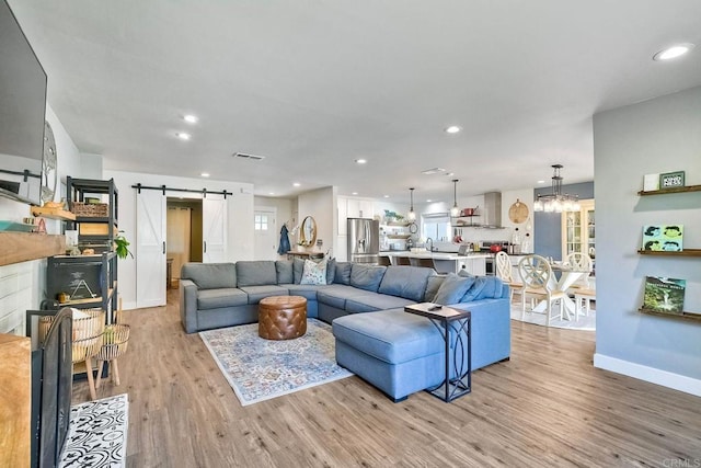 2760 Thunder Dr, Oceanside, CA 92056 - living area with a barn door, light wood-type flooring, recessed lighting, and a chandelier