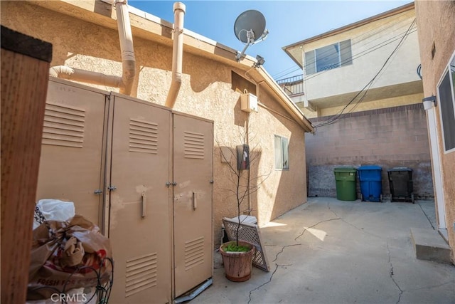 view of side of home with a patio and stucco siding
