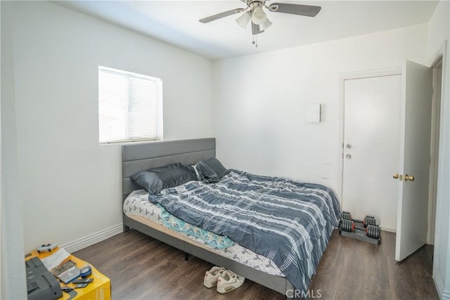 bedroom featuring baseboards, ceiling fan, and wood finished floors