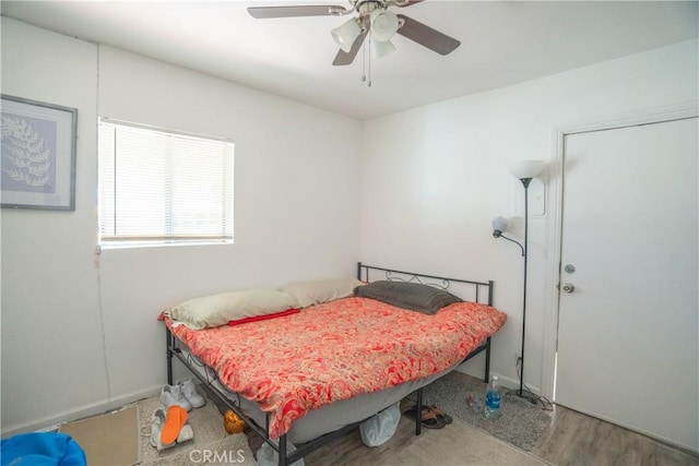 bedroom featuring ceiling fan and wood finished floors