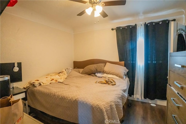 bedroom with ceiling fan and wood finished floors