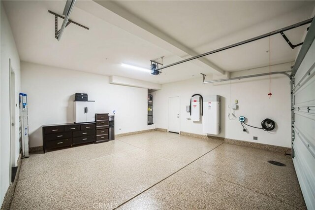 garage with a garage door opener and baseboards