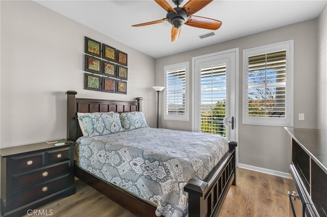 23757 Cahuilla Ct, Corona, CA 92883 - bedroom with access to outside, wood finished floors, baseboards, and ceiling fan