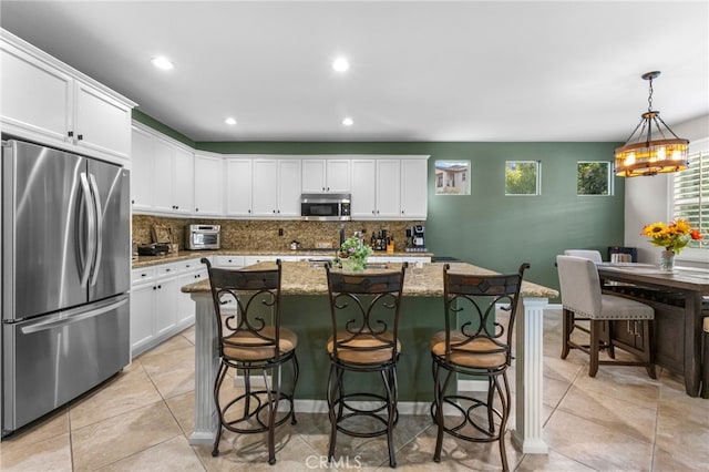23757 Cahuilla Ct, Corona, CA 92883 - kitchen with stainless steel appliances, decorative backsplash, white cabinets, and recessed lighting