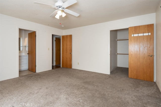 51674 Rd 426, Oakhurst, CA 93644 - unfurnished bedroom featuring carpet flooring, a spacious closet, connected bathroom, ceiling fan, and a closet