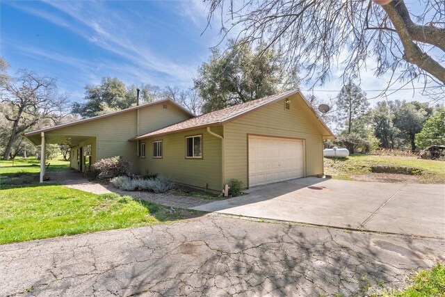 51674 Rd 426, Oakhurst, CA 93644 - view of home's exterior featuring a garage, concrete driveway, and a yard
