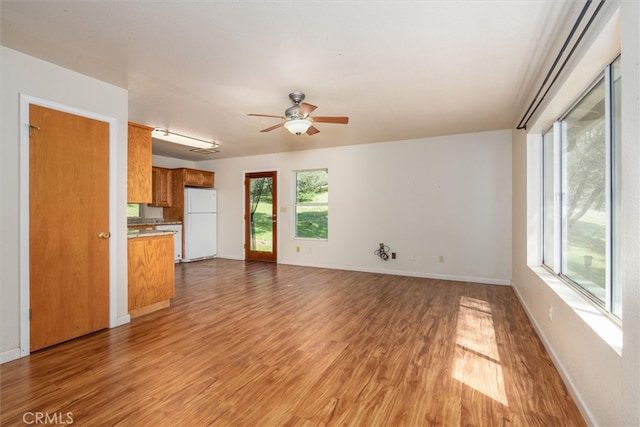 51674 Rd 426, Oakhurst, CA 93644 - unfurnished living room featuring baseboards, ceiling fan, and light wood finished floors